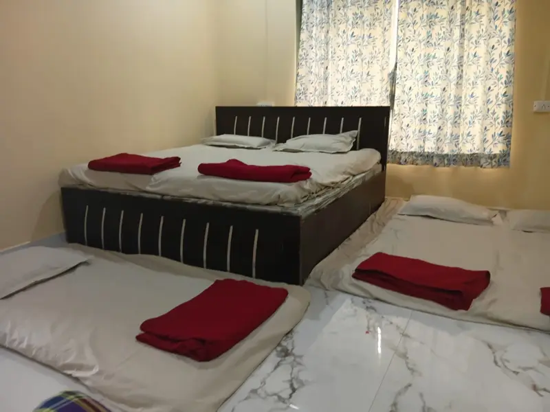 Private bedroom with double bed and floor bedding