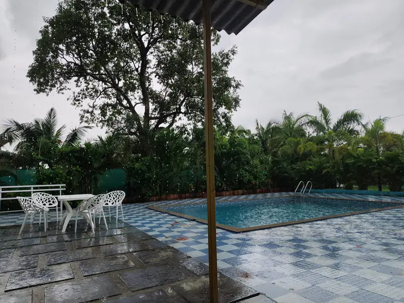 The private pool on its blue-and-white checkered deck, with garden beyond